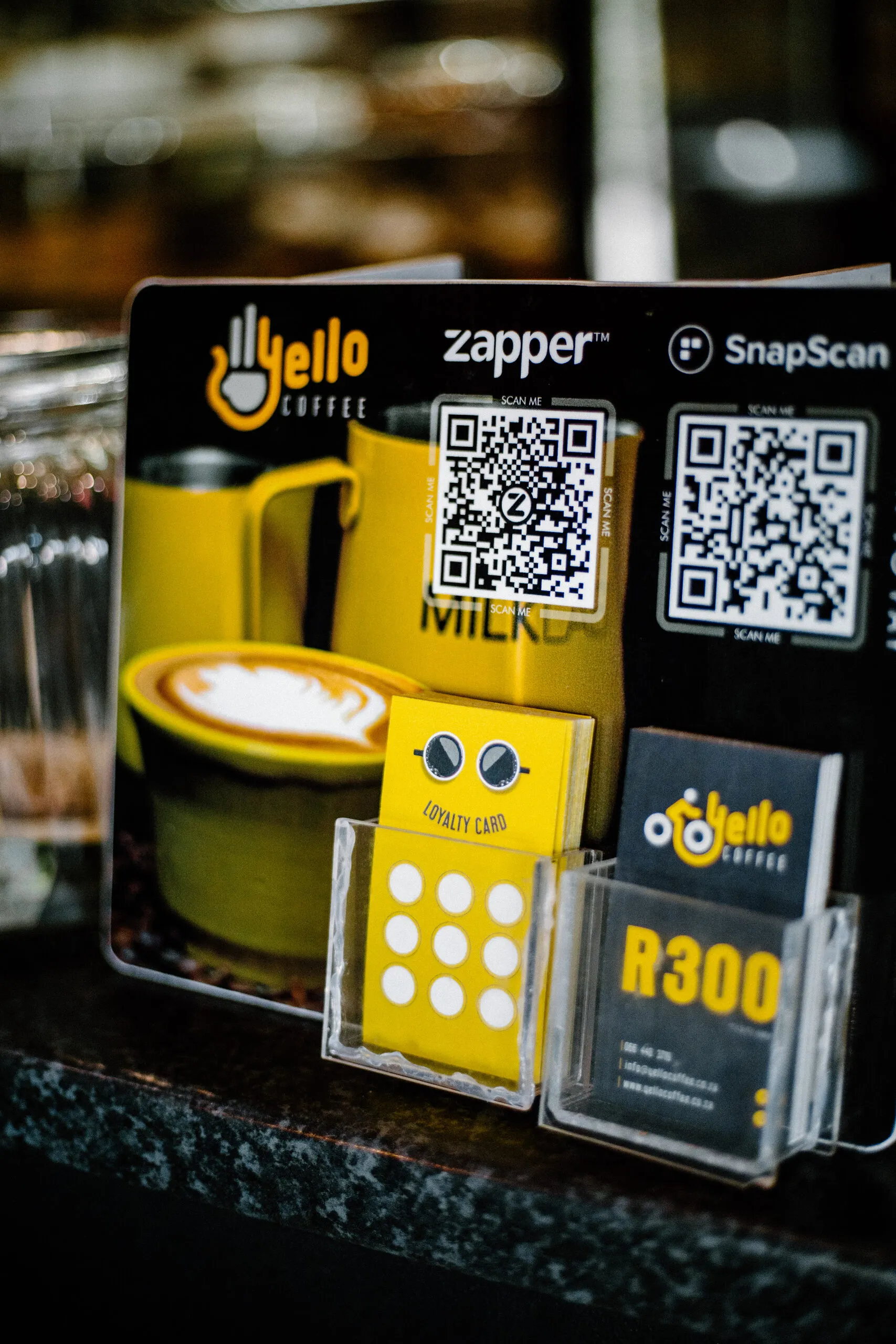 Loyalty cards, gift vouchers and SnapScan and Zapper QR codes on the counter
