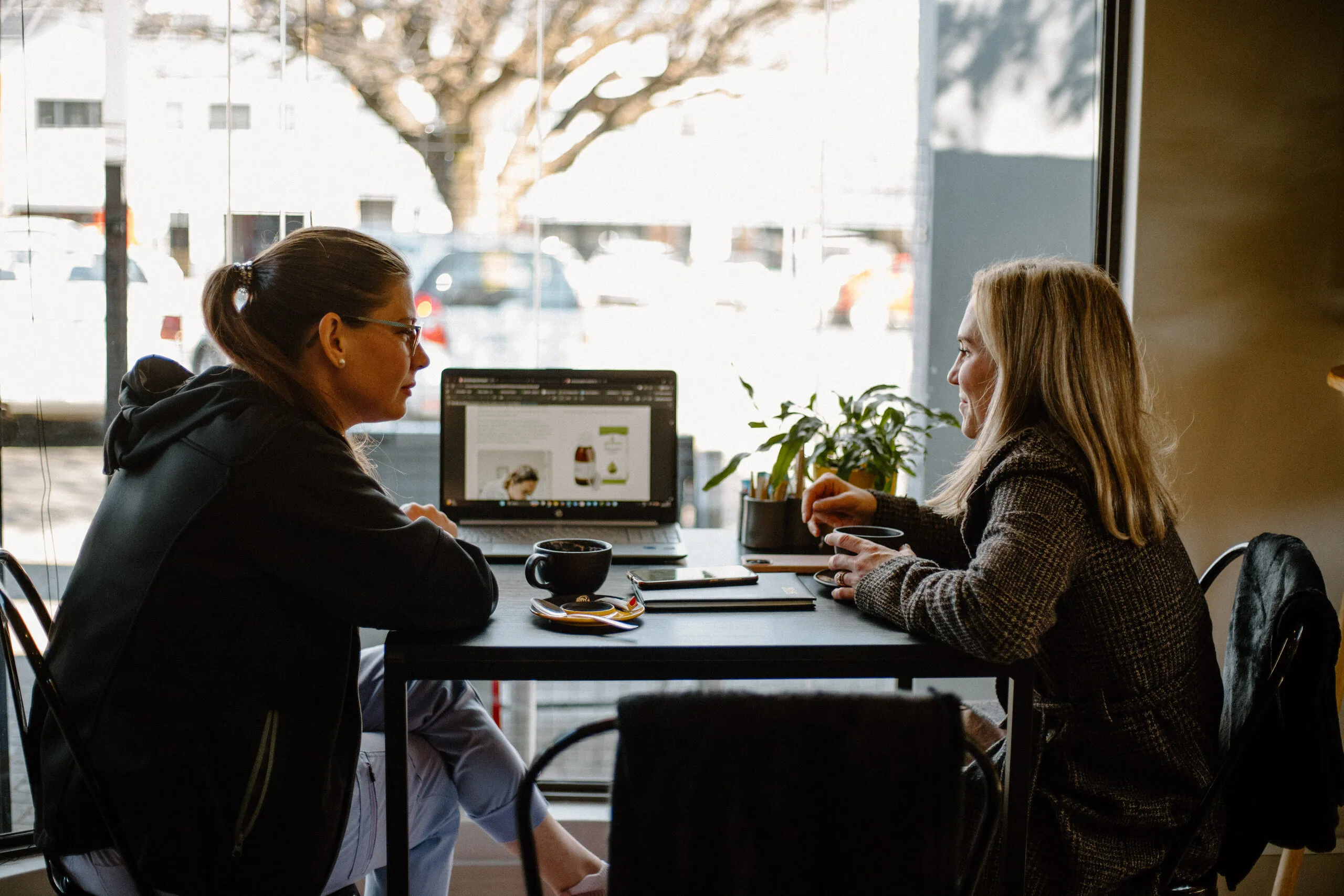 Customers at a window table inside Yello Coffee