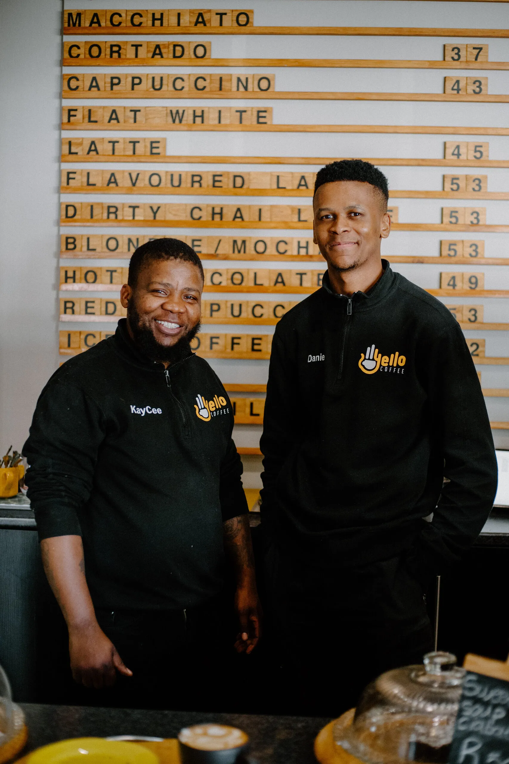 Two Yello Coffee baristas standing together behind the counter